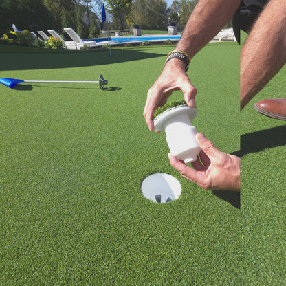 Video of someone holding a golf cup insert and showing how to adjust the height and set it in a golf cup on top of an artificial putting green. 