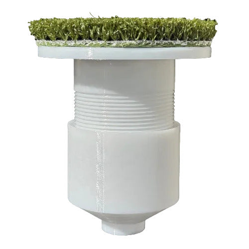 White cylindrical object with grass-like material on top against a white background